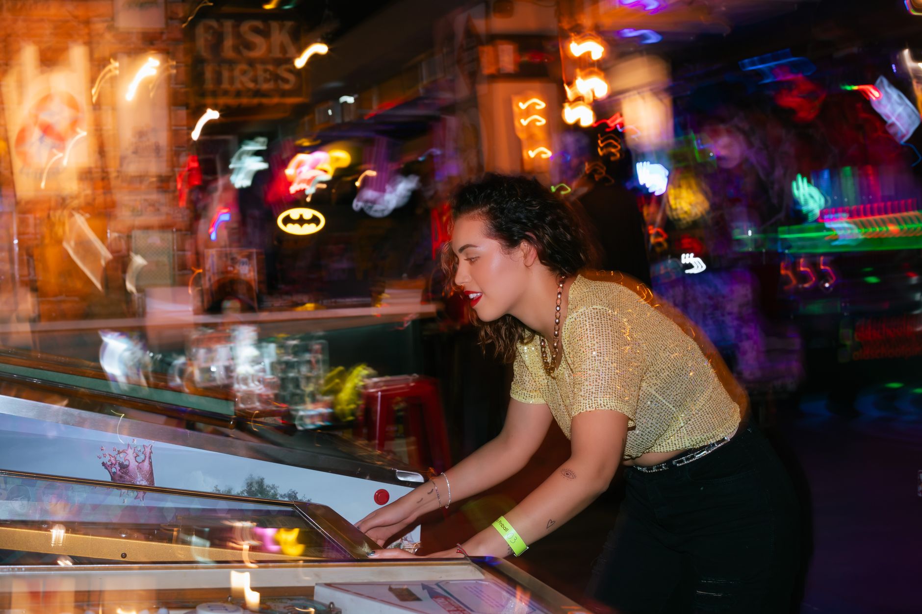 Young woman enjoying a night out playing pinball in an energetic arcade setting. — Accurate Football Predictions From This Se