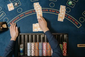 Dealer hands distributing cards at a casino blackjack table with chips in view. — Benefits and drawbacks of utilizing charge