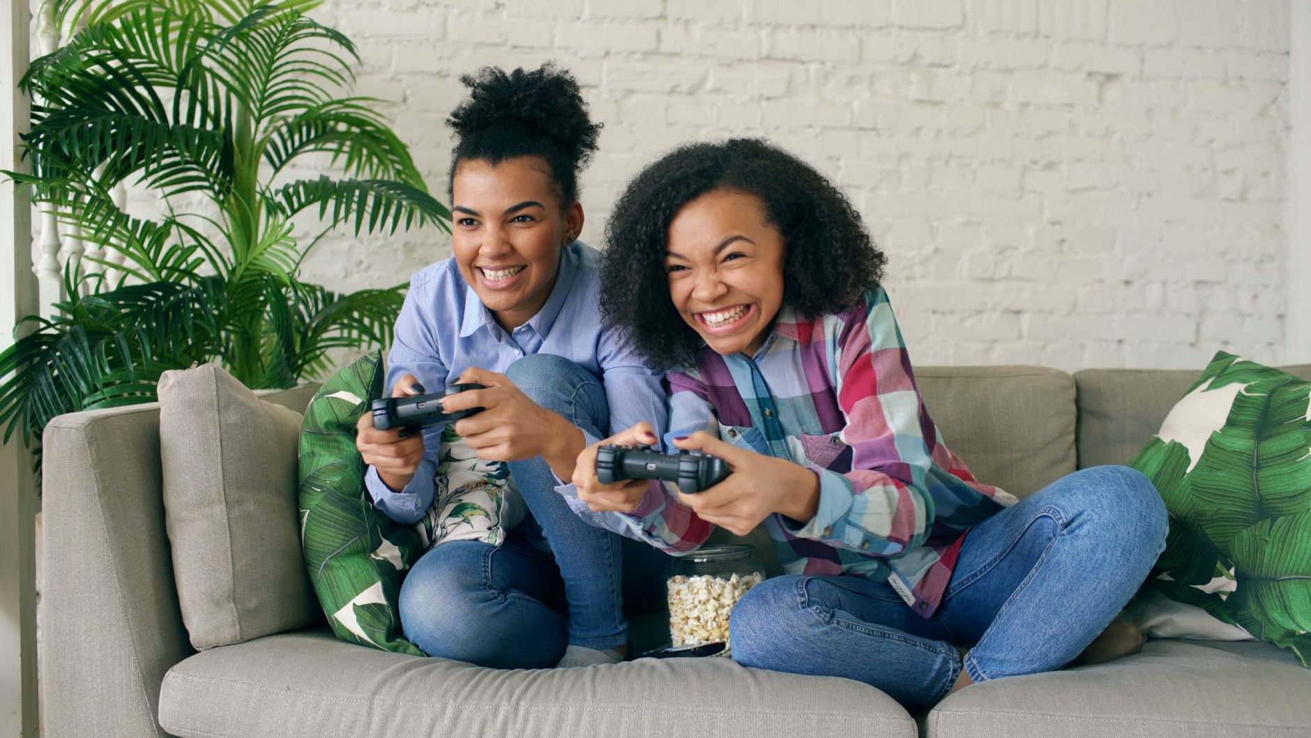 Two teenagers enjoying video games on a couch, showing excitement and joy. — Exploring Advanced Strategies for Soccer