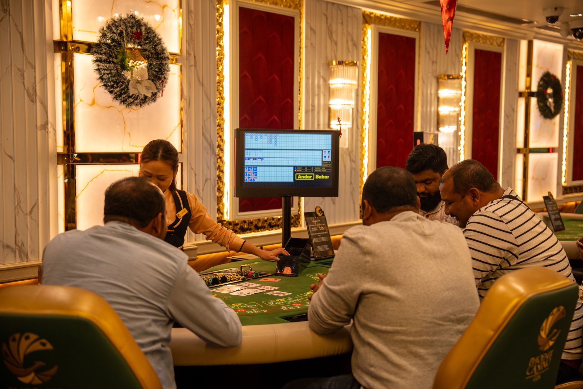 A group of adults playing at a casino table in Goa, India, captured indoors with festive decor. — The Different Types