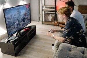 Two friends immersed in playing video games together in a cozy living room. — The Role of Online sodo casino in Our Lives: Wh