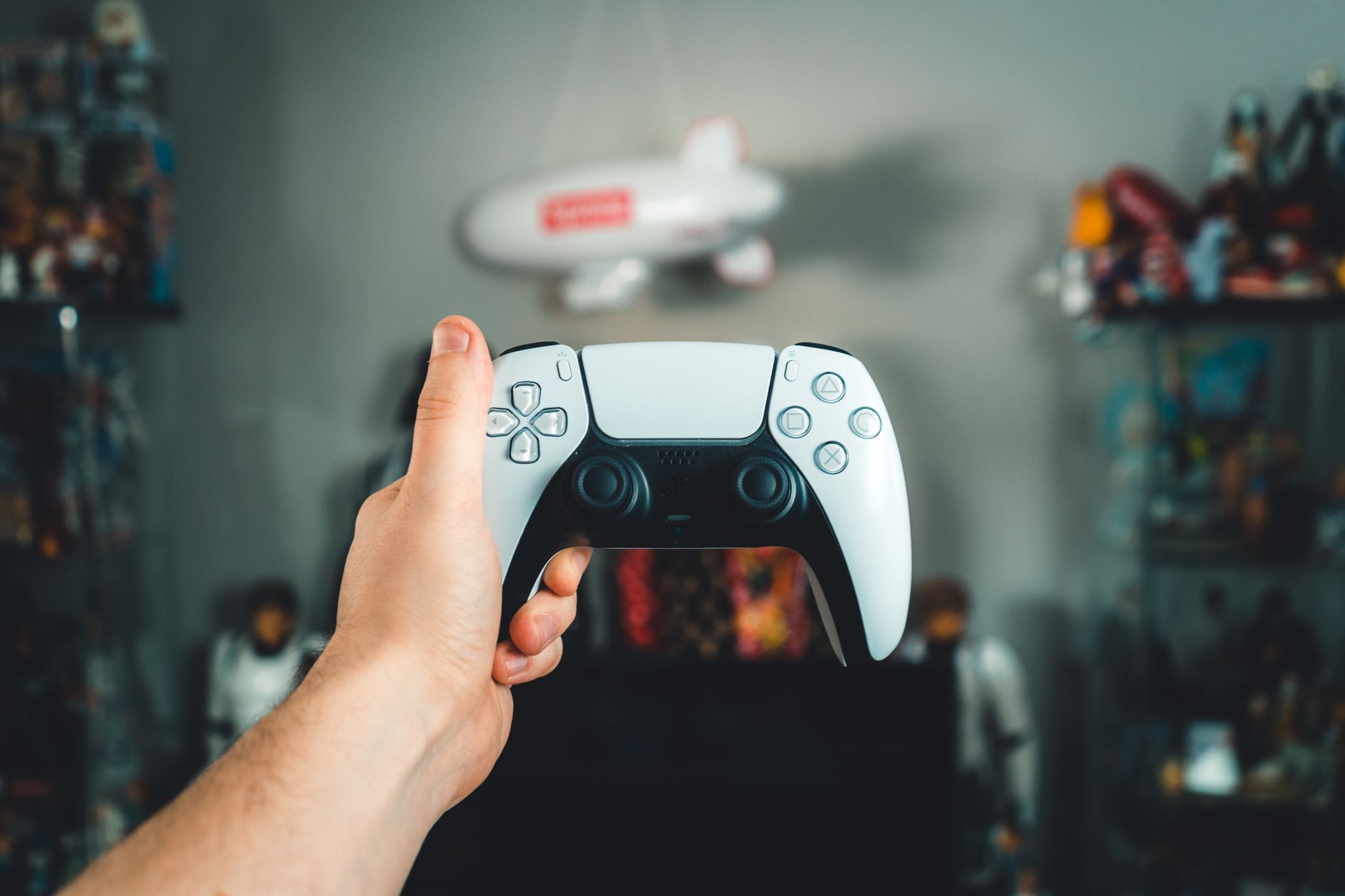 A close-up of a hand holding a sleek white gaming controller, showcasing modern design. — Using Sites That eat away For Casin