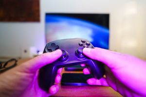 Close-up of hands holding a game controller in front of a TV screen. Perfect for entertainment setups. — Why do dice rolling