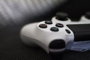 Close-up of a white gaming controller with action buttons.