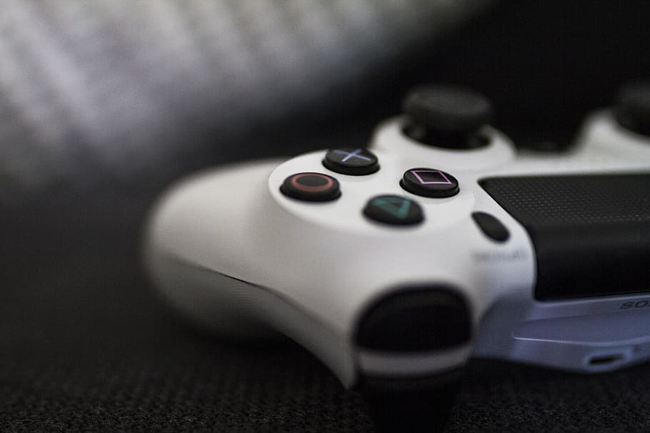Close-up of a white gaming controller with action buttons.
