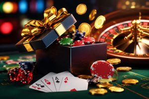 A gift box overflowing with poker chips, playing cards, and casino tokens on a green felt table next to a roulette wheel